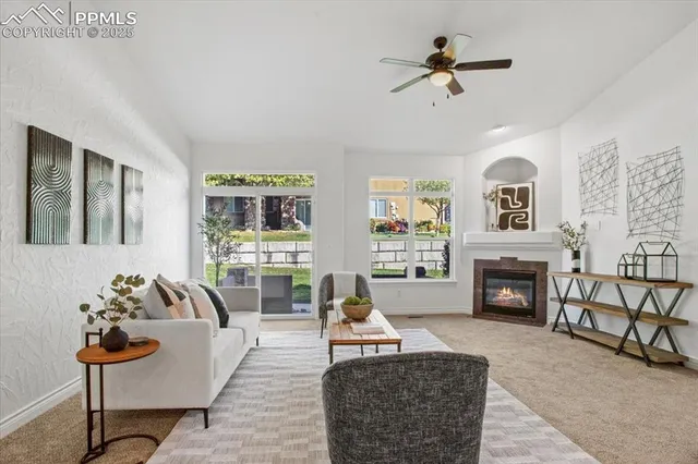 a living room with furniture a fireplace and a flat screen tv