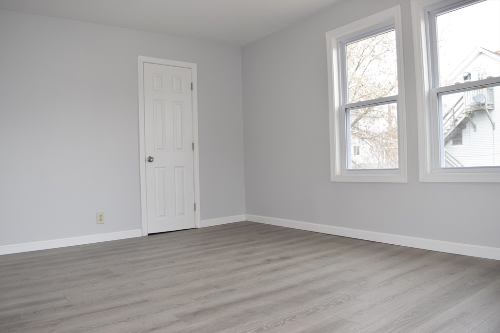7 Pearl Street Southbridge, MA 01550 - Photo 12 of 41 an empty room with wooden floor and windows