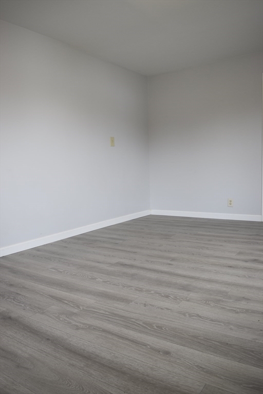 7 Pearl Street Southbridge, MA 01550 - Photo 13 of 41 a view of an empty room with wooden floor
