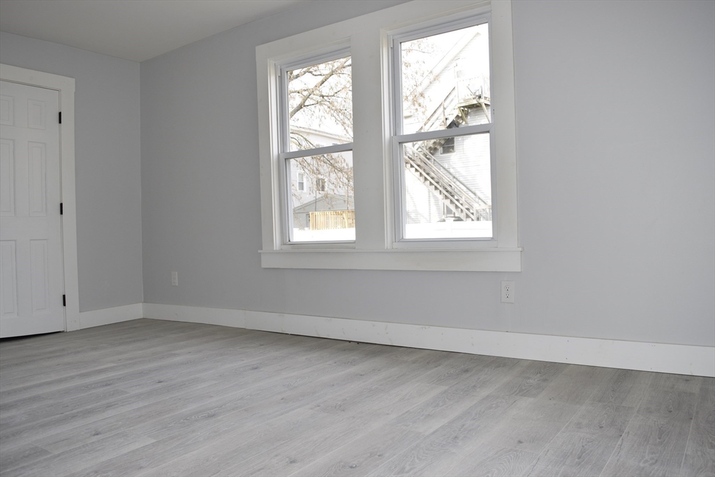 7 Pearl Street Southbridge, MA 01550 - Photo 17 of 41 an empty room with wooden floor and windows