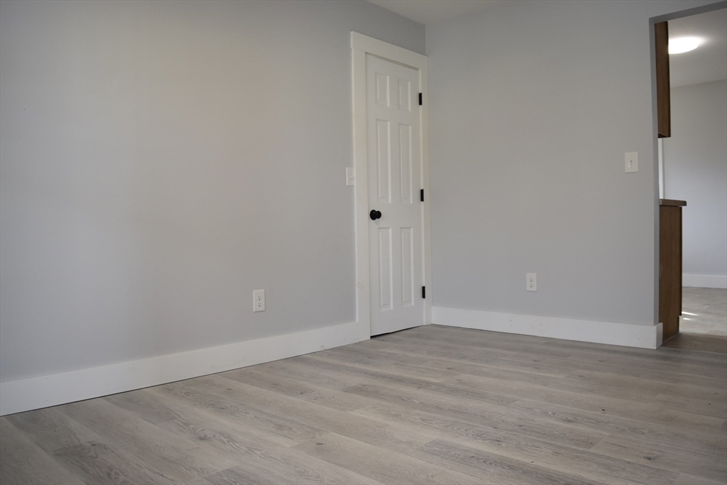 7 Pearl Street Southbridge, MA 01550 - Photo 22 of 41 a view of an empty room with wooden floor
