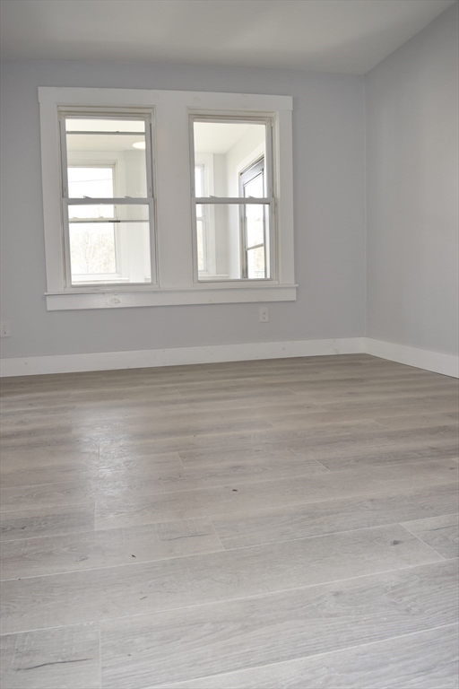 7 Pearl Street Southbridge, MA 01550 - Photo 23 of 41 a view of an empty room with wooden floor and a window