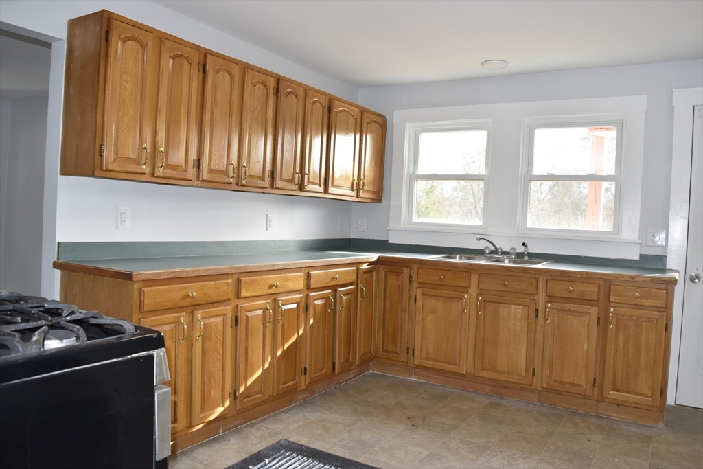 7 Pearl Street Southbridge, MA 01550 - Photo 24 of 41 a kitchen with stainless steel appliances granite countertop a stove a sink and a refrigerator