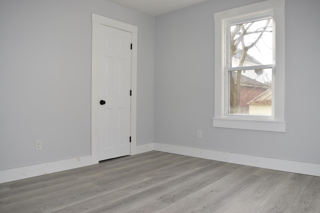 7 Pearl Street Southbridge, MA 01550 - Photo 26 of 41 an empty room with wooden floor and windows