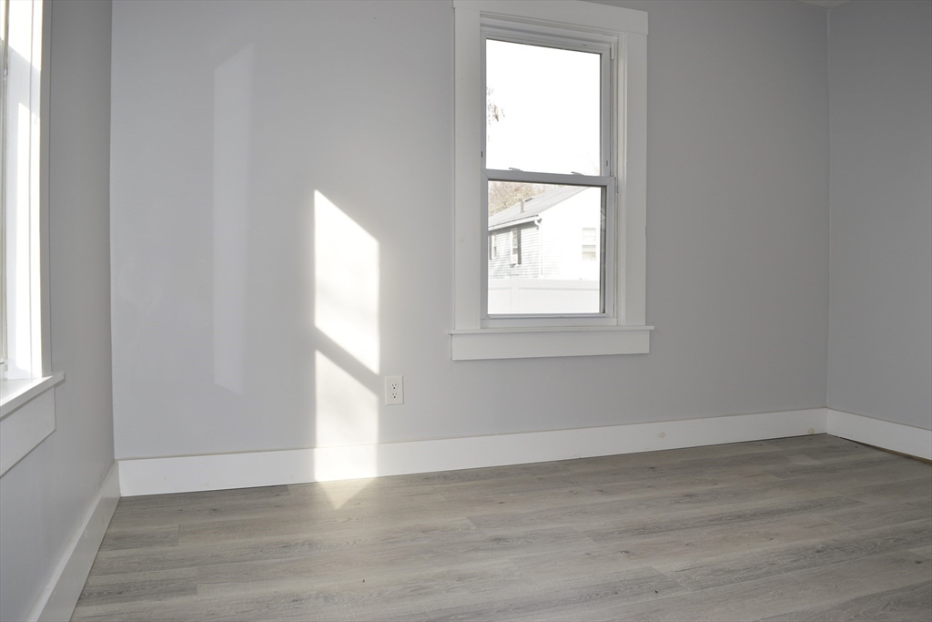7 Pearl Street Southbridge, MA 01550 - Photo 28 of 41 an empty room with wooden floor and windows