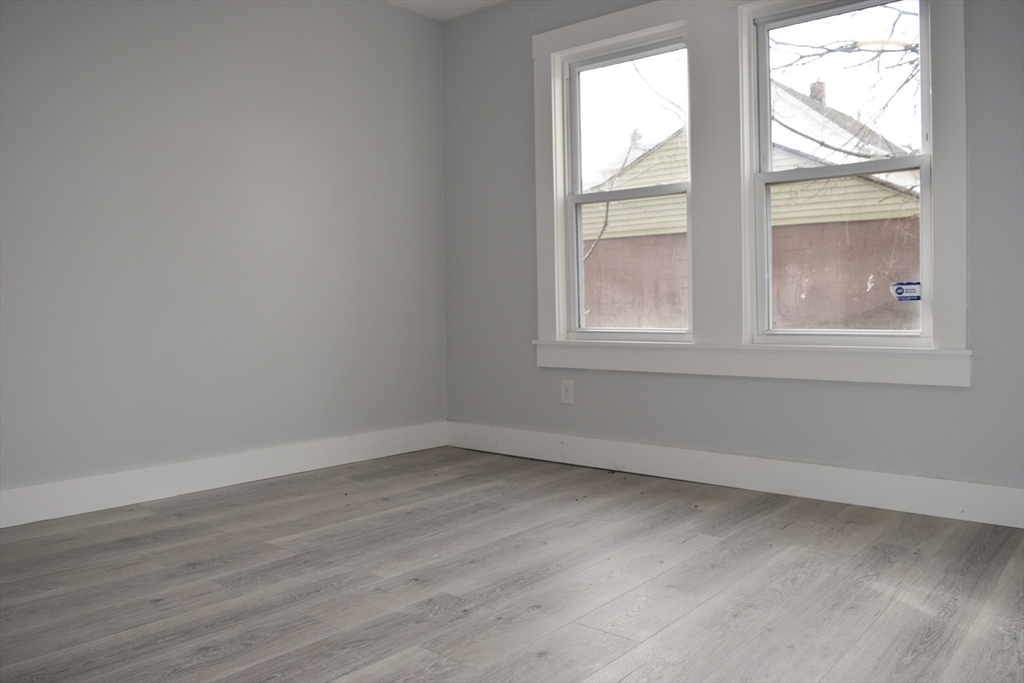 7 Pearl Street Southbridge, MA 01550 - Photo 29 of 41 an empty room with wooden floor and windows