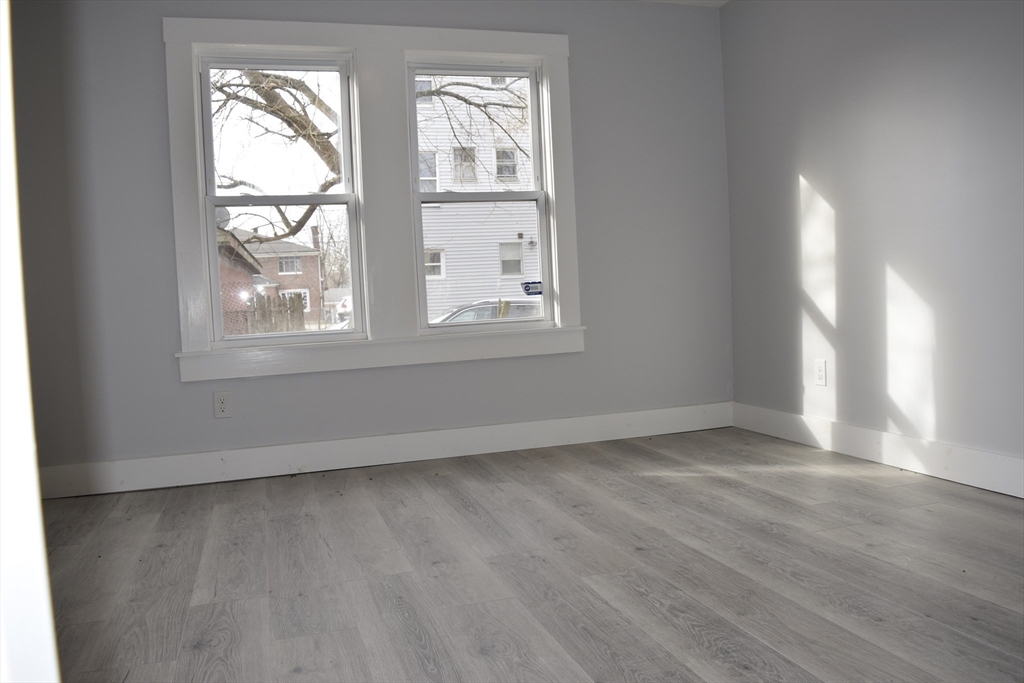 7 Pearl Street Southbridge, MA 01550 - Photo 30 of 41 an empty room with wooden floor and windows