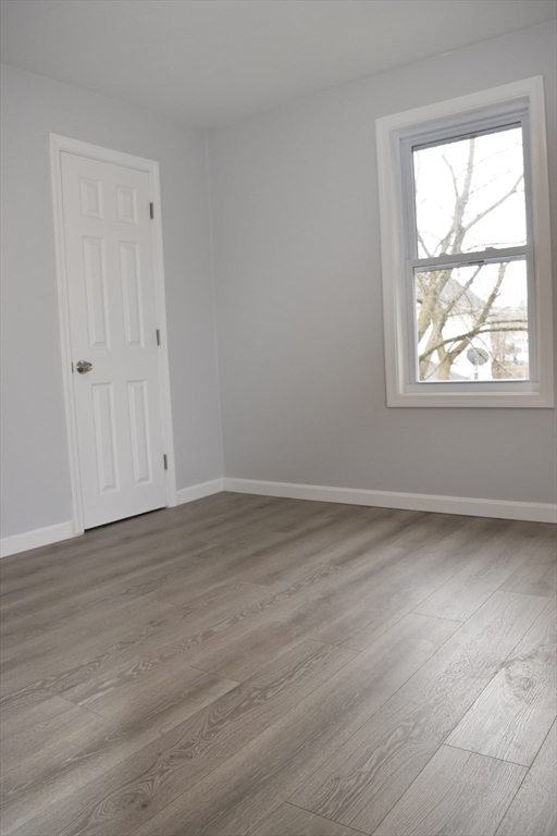 7 Pearl Street Southbridge, MA 01550 - Photo 5 of 41 a view of an empty room with wooden floor and a window