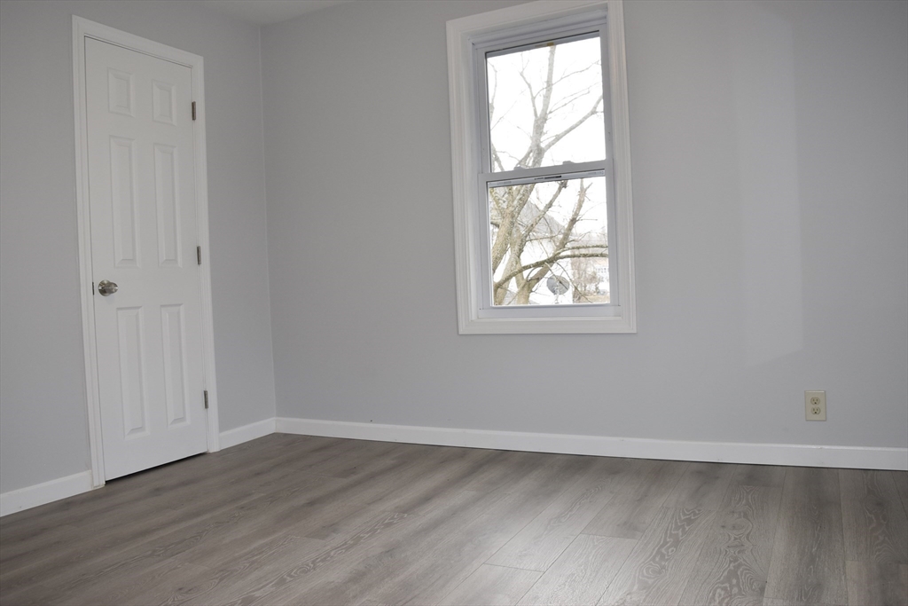 7 Pearl Street Southbridge, MA 01550 - Photo 6 of 41 an empty room with wooden floor and windows