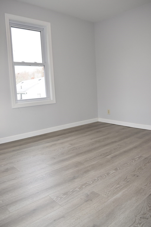 7 Pearl Street Southbridge, MA 01550 - Photo 7 of 41 an empty room with wooden floor and windows