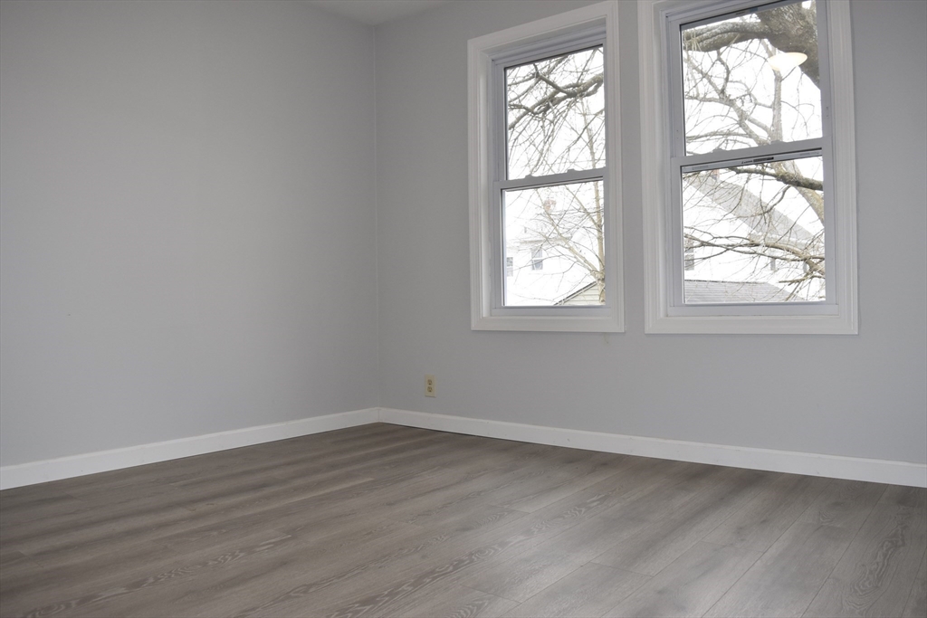 7 Pearl Street Southbridge, MA 01550 - Photo 10 of 41 an empty room with wooden floor and windows