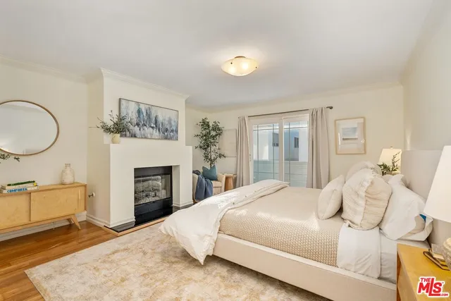 a bedroom with a large bed and a fireplace