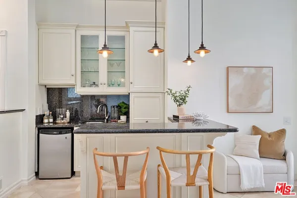 a kitchen with stainless steel appliances granite countertop a white cabinets and a refrigerator