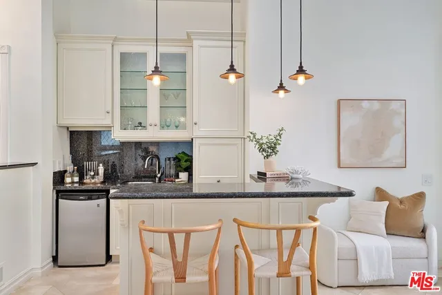 a kitchen with stainless steel appliances granite countertop a white cabinets and a refrigerator