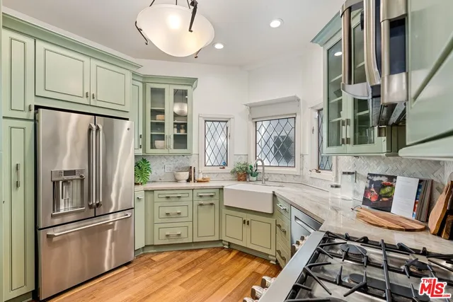 a kitchen with stainless steel appliances a stove a sink and a refrigerator