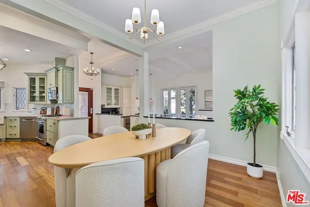 a view of a dining room with furniture and a potted plant