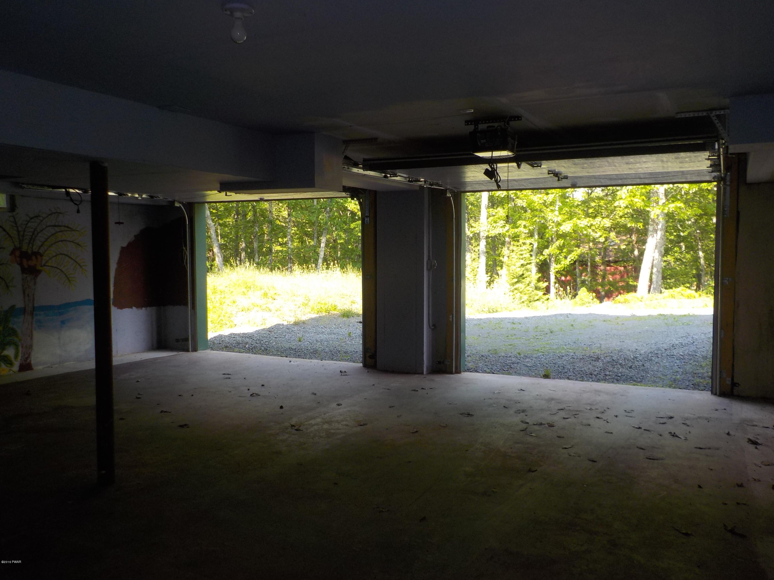 230 Maple Ridge Drive Hawley, PA 18428 - Photo 28 of 35 a view of large room with large windows and a fireplace