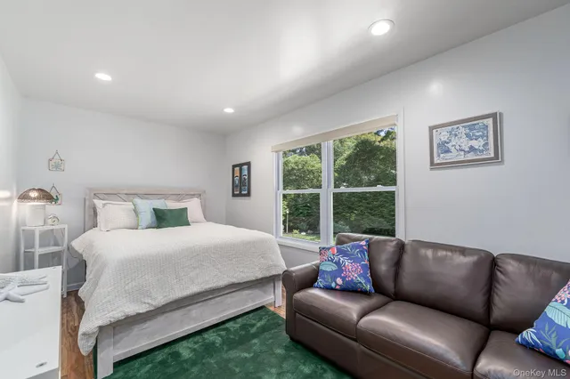 a bedroom with a bed couch and window