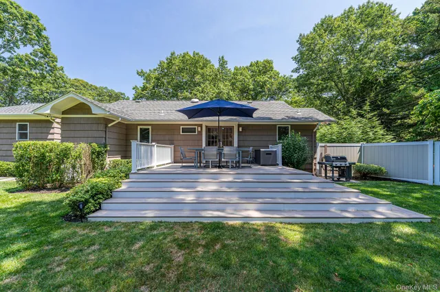 a front view of a house with yard and green space