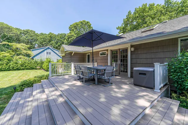 a view of a house with backyard and sitting area