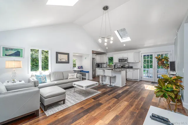 a living room with furniture and kitchen view