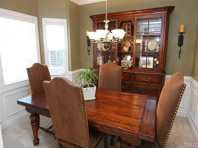 4824 Morning Edge Drive Raleigh, NC 27613 - Photo 3 of 12 a view of a dining room with furniture window and outside view