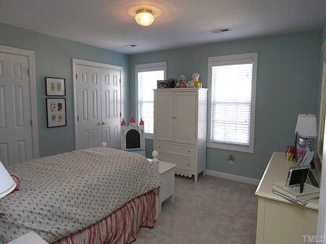 4824 Morning Edge Drive Raleigh, NC 27613 - Photo 7 of 12 a bedroom with a bed and a window