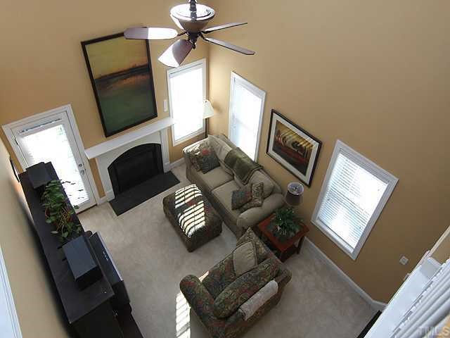 4824 Morning Edge Drive Raleigh, NC 27613 - Photo 10 of 12 a living room with furniture fireplace and a flat screen tv