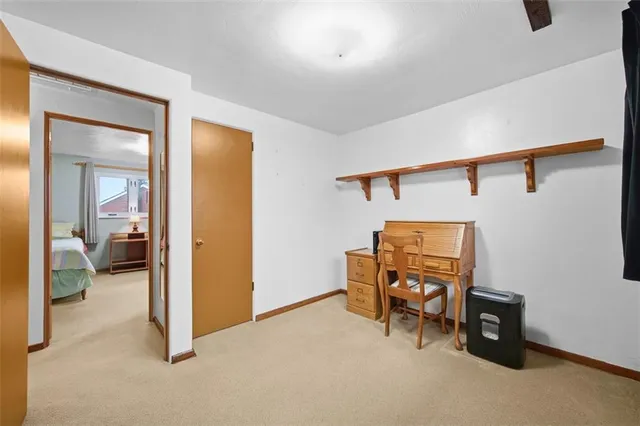 a view of a room that has a bed and a view of bathroom