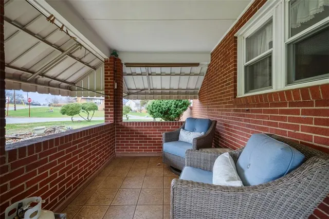 a view of a chairs and table in the balcony