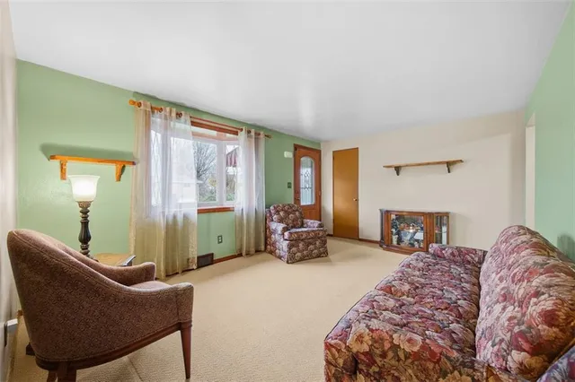 a bedroom with furniture and a large window