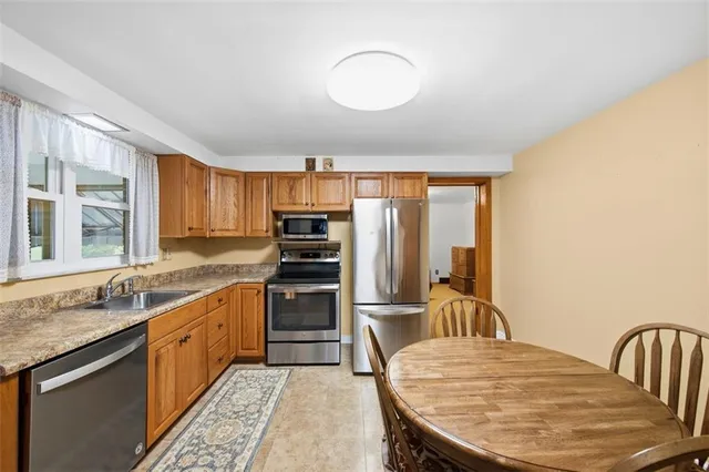 a kitchen with a stove a sink and a refrigerator