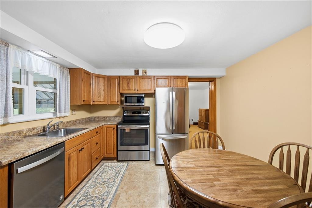 108 Starling Drive McKees Rocks, PA 15136 - Photo 8 of 37 a kitchen with a stove a sink and a refrigerator