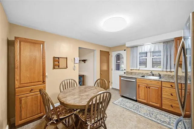a view of a a dining room with furniture window and wooden floor