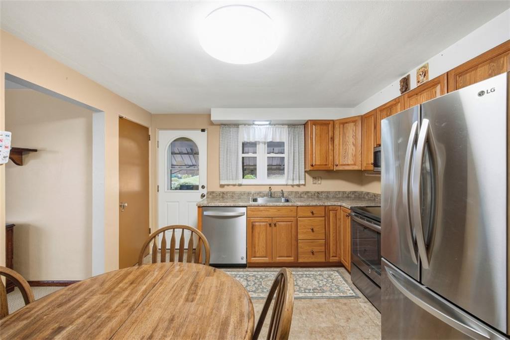 108 Starling Drive McKees Rocks, PA 15136 - Photo 10 of 37 a kitchen with stainless steel appliances granite countertop a refrigerator a sink a stove and island