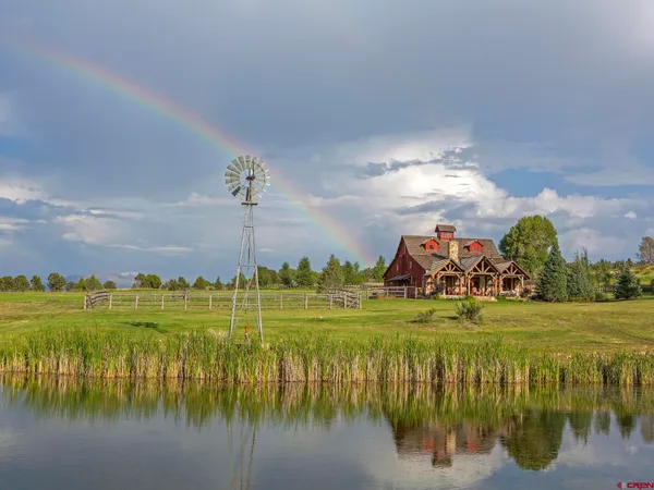 a view of a lake and a yard from a balcony