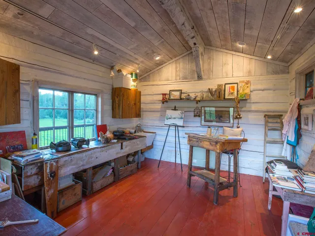 a view of a porch with furniture and garden