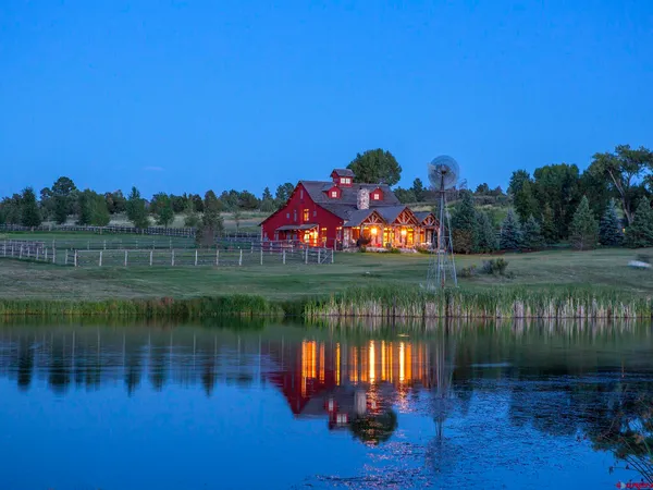 a lake view with a big yard
