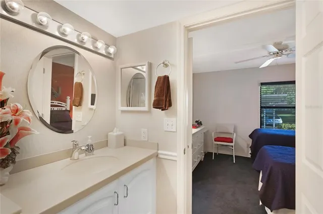 a bathroom with a toilet a sink and a mirror