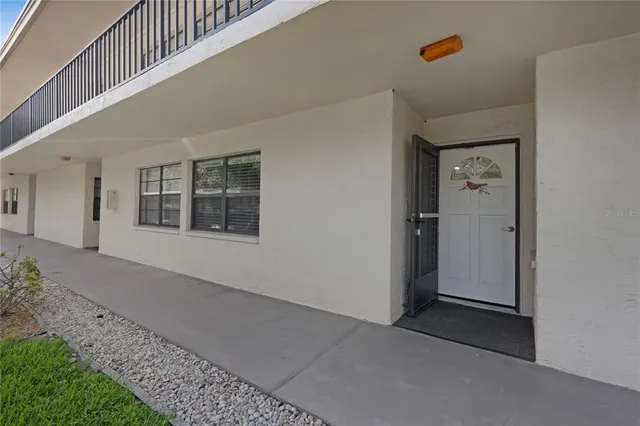 a view of a hallway with wooden floor and entryway
