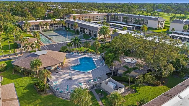 a view of a house with swimming pool and sitting area