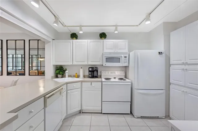 a white refrigerator freezer sitting inside of a kitchen