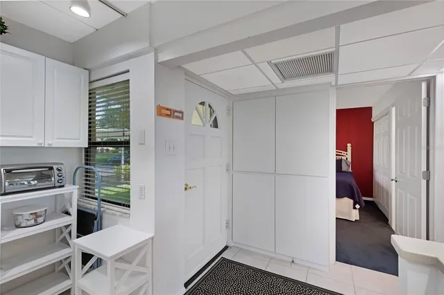 a bedroom with two beds and a chandelier