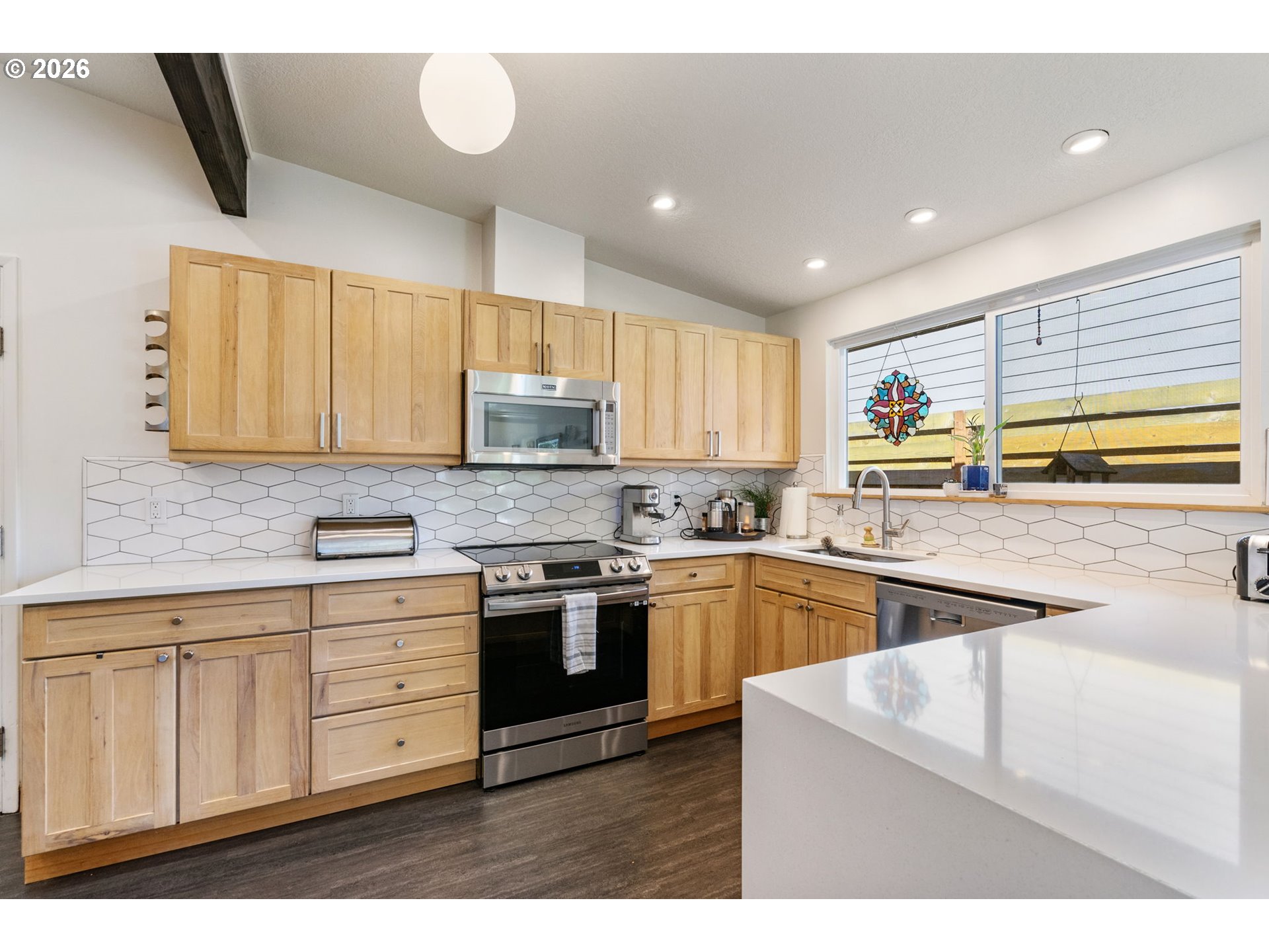 13410 Northwest Overton Street Portland, OR 97229 - Photo 16 of 48 a kitchen with stainless steel appliances granite countertop a stove a sink and a microwave