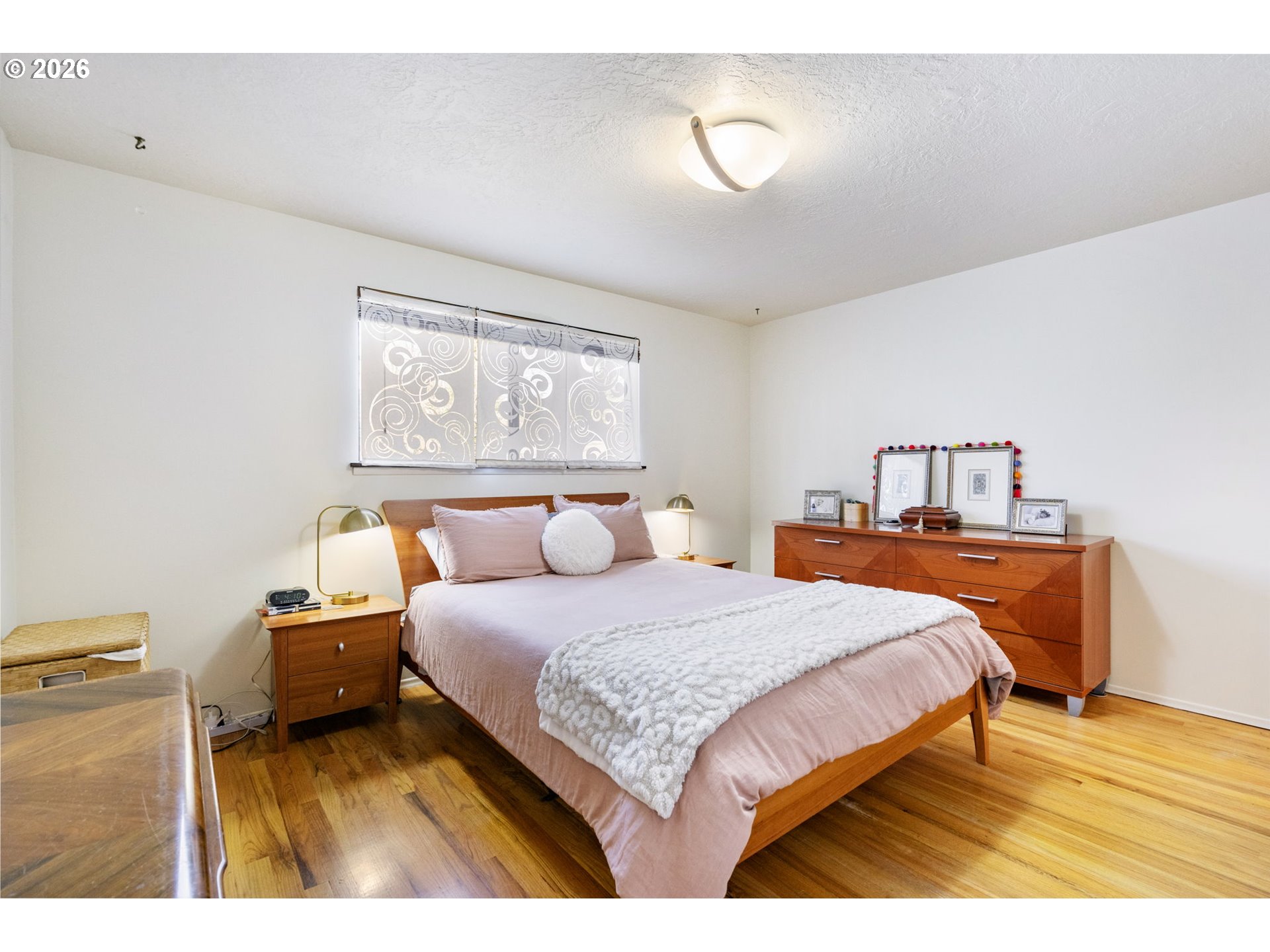 13410 Northwest Overton Street Portland, OR 97229 - Photo 22 of 48 a bedroom with a bed and wooden floor