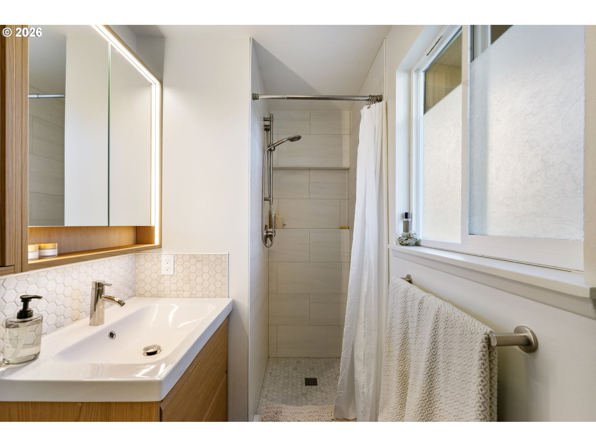 13410 Northwest Overton Street Portland, OR 97229 - Photo 24 of 48 a bathroom with a sink mirror and shower