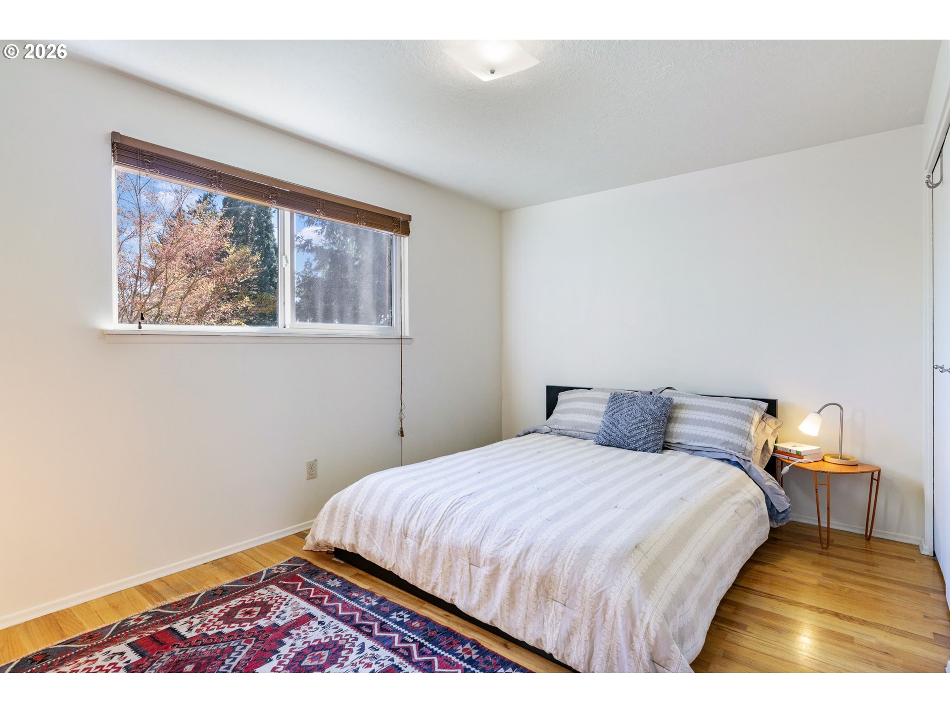 13410 Northwest Overton Street Portland, OR 97229 - Photo 25 of 48 a bedroom with a bed and wooden floor