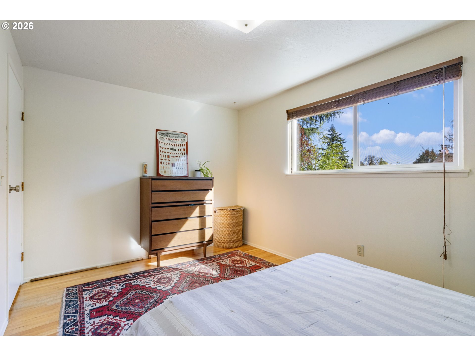 13410 Northwest Overton Street Portland, OR 97229 - Photo 26 of 48 a bedroom with a bed and a painting on the wall