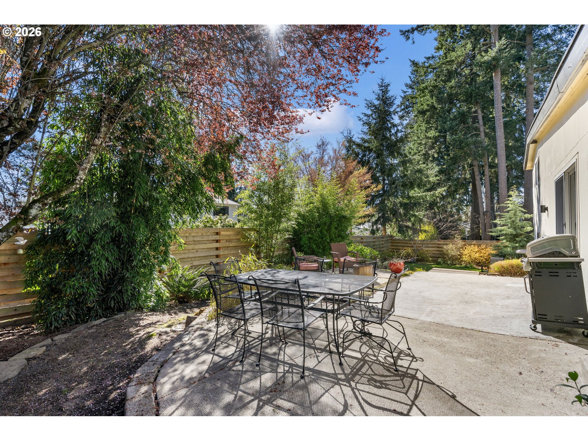 13410 Northwest Overton Street Portland, OR 97229 - Photo 36 of 48 a view of a patio with table and chairs and potted plants with large tree