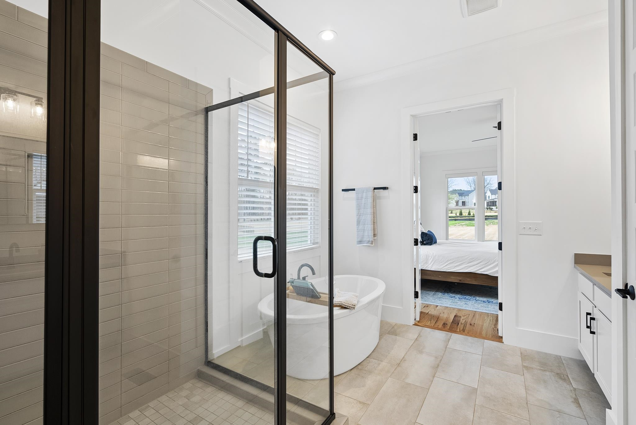 1004 Harrison Ridge Road Wake Forest, NC 27587 - Photo 25 of 48 a bathroom with a tub shower vanity and a sink